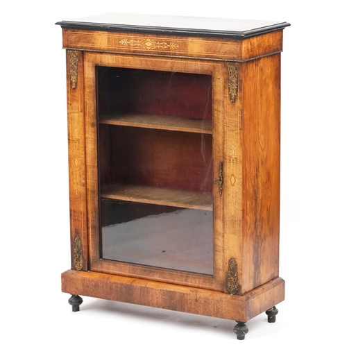 1052 - A mid Victorian walnut pier cabinet with gilt metal mounts and glazed panel door, raised on turned f... 