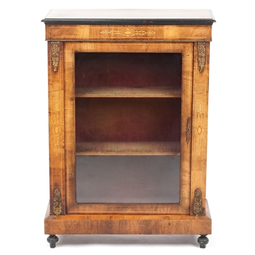 1052 - A mid Victorian walnut pier cabinet with gilt metal mounts and glazed panel door, raised on turned f... 