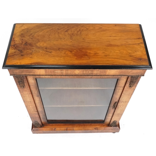 1052 - A mid Victorian walnut pier cabinet with gilt metal mounts and glazed panel door, raised on turned f... 