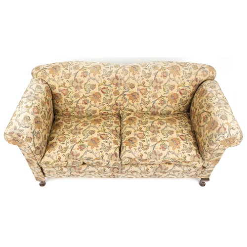  A late Victorian drop end two seat settee upholstered in floral damask, raised on cabriole legs, 88c... 