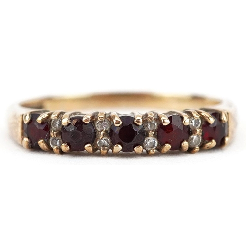 394 - A 9ct gold garnet and cubic zirconia half eternity ring, size R, 2.3g.