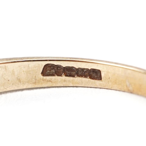 394 - A 9ct gold garnet and cubic zirconia half eternity ring, size R, 2.3g.