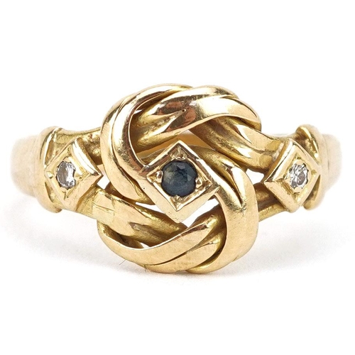 An 18ct gold knot design ring set with a central sapphire and two diamonds, indistinct hallmarks, size R, 4.5g.