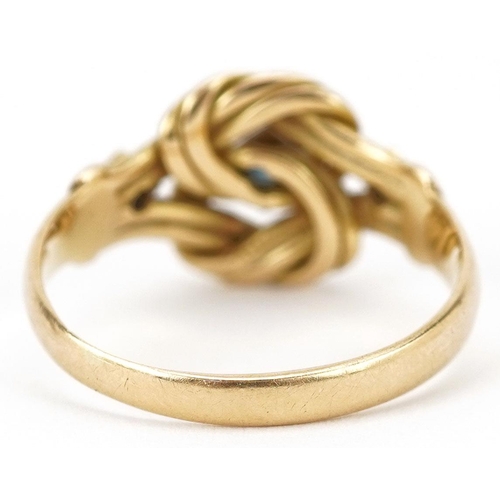  An 18ct gold knot design ring set with a central sapphire and two diamonds, indistinct hallmarks, si... 