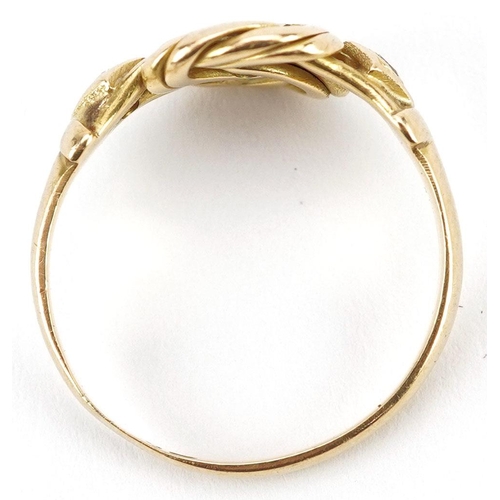  An 18ct gold knot design ring set with a central sapphire and two diamonds, indistinct hallmarks, si... 