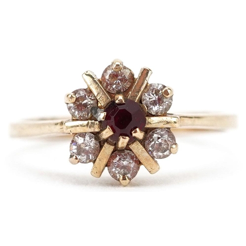 357 - A 9ct gold flower head ring set with red and clear stones, size P, 2.3g.