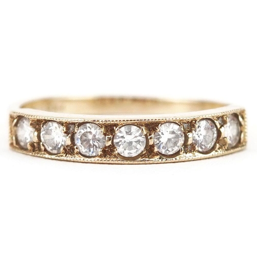 399 - A 9ct gold cubic zirconia half eternity ring set with seven stones, size O, 1.9g.