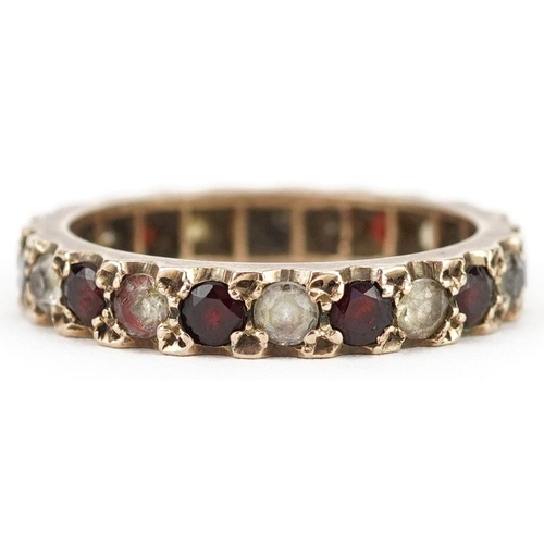 425 - A 9ct gold garnet and clear stone eternity ring, size Q, 3.5g.