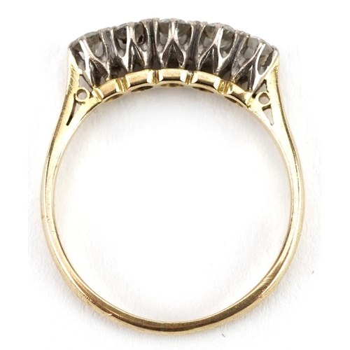  An 18ct gold graduated diamond five stone ring, the central diamond approximately 3.35mm in diameter... 