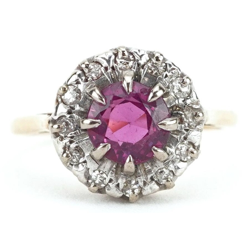 285 - An unmarked gold ruby and diamond cluster ring, the ruby approximately 6.90mm in diameter x 4.70mm d... 