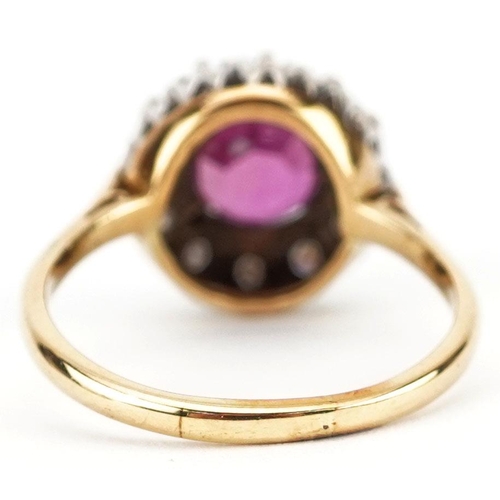 285 - An unmarked gold ruby and diamond cluster ring, the ruby approximately 6.90mm in diameter x 4.70mm d... 