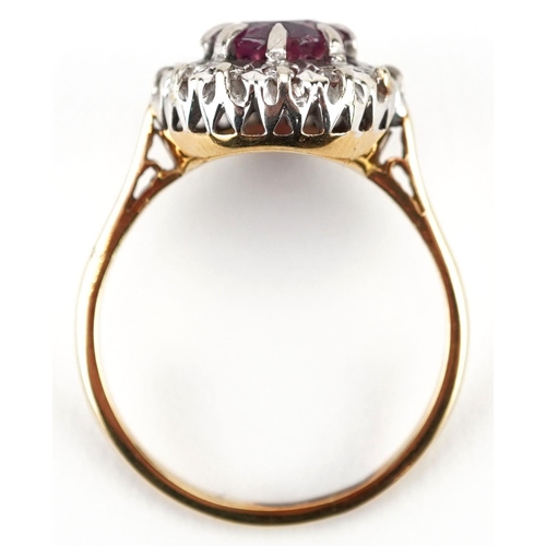 285 - An unmarked gold ruby and diamond cluster ring, the ruby approximately 6.90mm in diameter x 4.70mm d... 