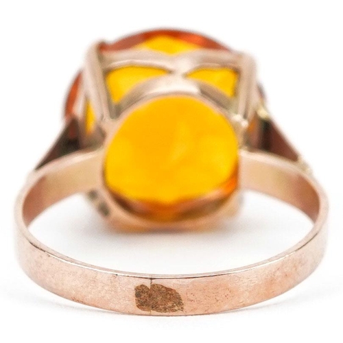 211 - A continental gold orange stone solitaire ring, the stone approximately 13.0mm x 8.50mm deep, size M... 