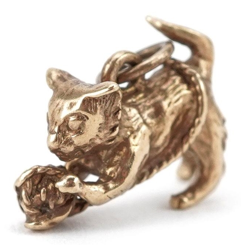 410 - A 9ct gold charm in the form of a cat with a ball of yarn, 1.5cm in length, 2.5g.