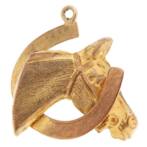  A 9ct gold charm in the form of a horse head and horseshoe, 2.1cm high, 1.8g.