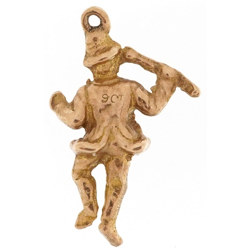 329 - A 9ct gold charm in the form of a jolly gentleman, 2.7cm high, 2.9g.