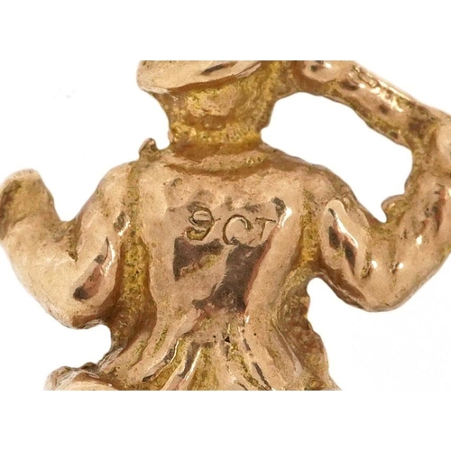 329 - A 9ct gold charm in the form of a jolly gentleman, 2.7cm high, 2.9g.