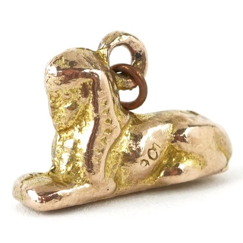 419 - A 9ct gold charm in the form of a sphynx, 1.8cm in length, 4.6g.