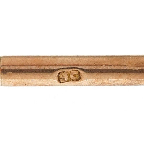 221 - A 9ct rose gold T bar, 3.8cm in length, 1.7g.