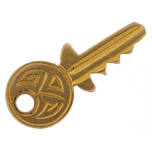 593 - A 9ct gold charm in the form of a key, 1.5cm high, 0.3g.