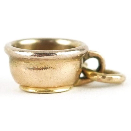 604 - An unmarked gold charm in the form of a chamber pot, 1.1cm in length, 1.2g.