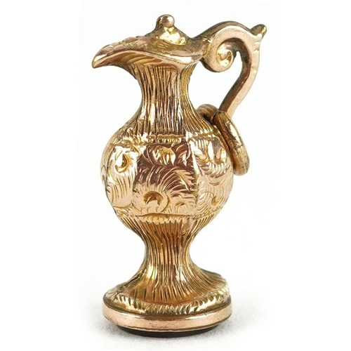 288 - A 9ct gold charm in the form of a wine ewer with carnelian base, 2cm high, 1.9g.