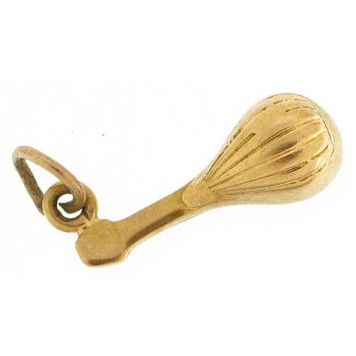 578 - A 9ct gold charm in the form of a mandolin, 1.5cm in length, 1.0g.