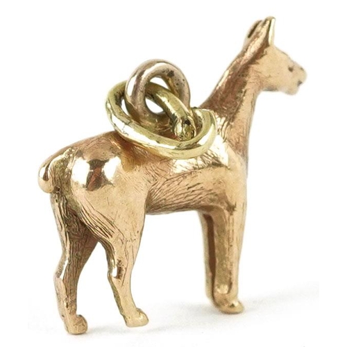 310 - An unmarked gold charm in the form of a horse, 1.4cm high, 1.7g.