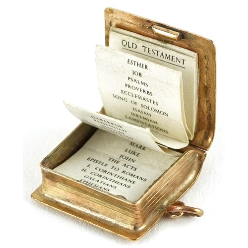 234 - An opening 9ct gold charm in the form of a holy bible, 2.1cm high, 2.7g.