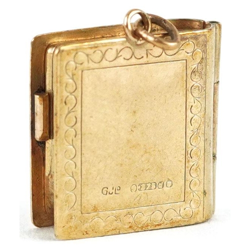 234 - An opening 9ct gold charm in the form of a holy bible, 2.1cm high, 2.7g.