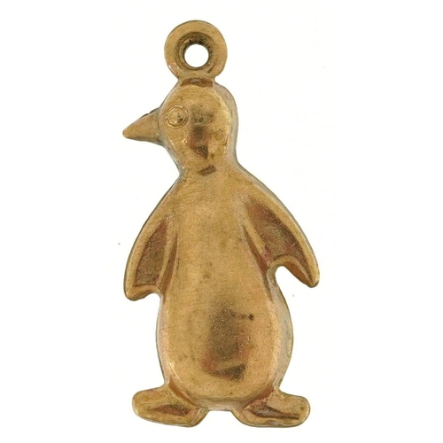 314 - An unmarked gold charm in the form of a penguin, (tests as 9ct gold), 2.2cm high, 1.2g.