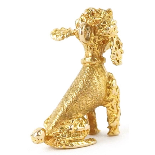 128 - A 9ct gold charm in the form of a seated Poodle, 2.0cm high, 6.5g.