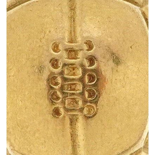 212 - A 9ct gold charm in the form of a football, 1.7cm high, 1.4g.