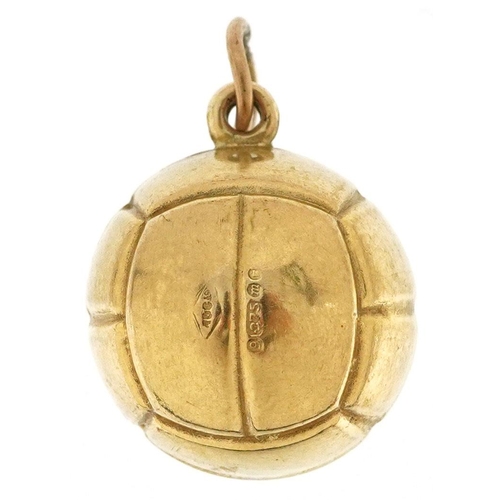 212 - A 9ct gold charm in the form of a football, 1.7cm high, 1.4g.