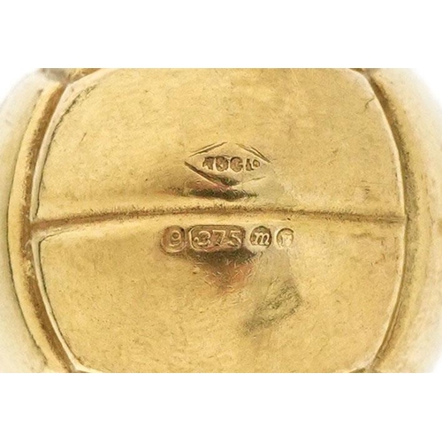 212 - A 9ct gold charm in the form of a football, 1.7cm high, 1.4g.