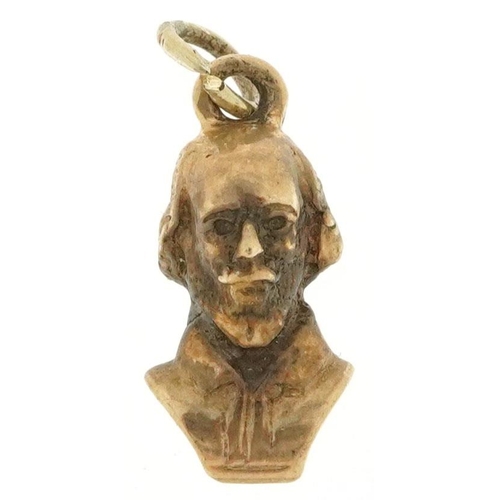 574 - A 9ct gold charm in the form of a bust of Shakespeare, 1.6cm high, 2.3g.