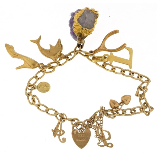  A 9ct gold charm bracelet with a selection of mostly 9ct gold charms and unmarked charms including a... 