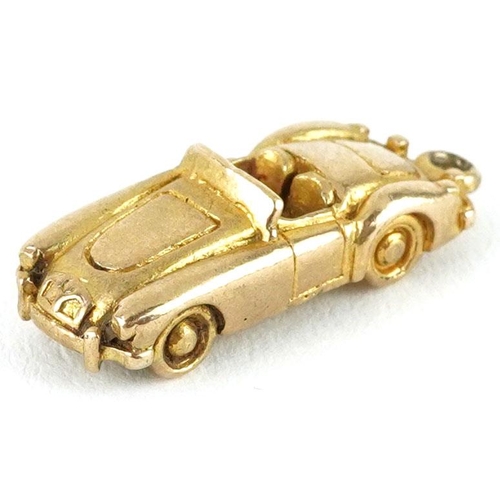 407 - A 9ct gold charm in the form of a car, 2.2cm in length, 4.0g.