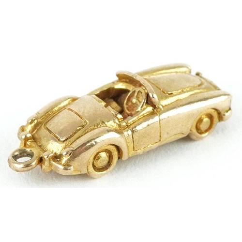 407 - A 9ct gold charm in the form of a car, 2.2cm in length, 4.0g.