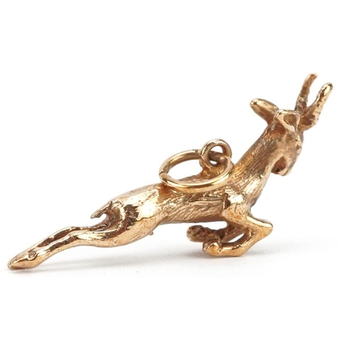 146 - A 9ct gold charm in the form of a leaping gazelle, 2.8cm in length, 3.1g.