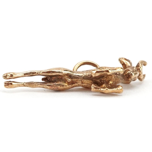 146 - A 9ct gold charm in the form of a leaping gazelle, 2.8cm in length, 3.1g.