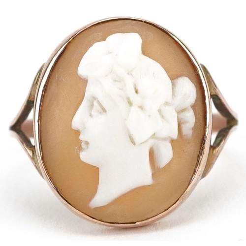 297 - An unmarked rose gold cameo shell ring carved with a maiden head, size Q, 4.9g.