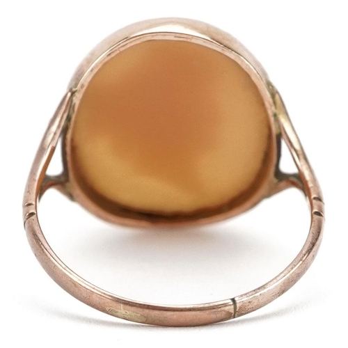 297 - An unmarked rose gold cameo shell ring carved with a maiden head, size Q, 4.9g.