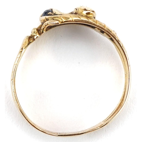  An antique unmarked gold ring in the form of two entwined serpents, set with a ruby and sapphire, si... 