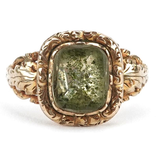 An antique unmarked gold green stone ring with ornate floral setting, size Q, 3.1g.