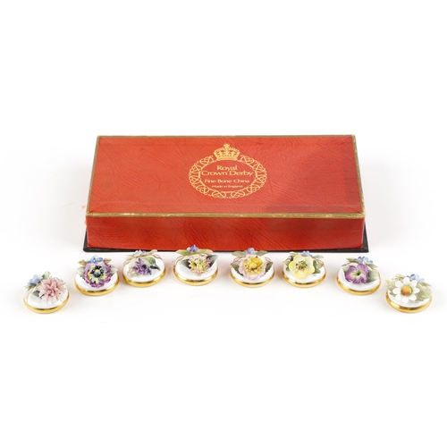 1338 - A set of eight Royal Crown Derby fine bone china menu holders with floral decoration, boxed.