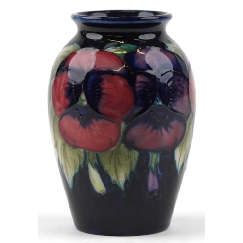 27 - A small Moorcroft hand painted pottery vase decorated with flowers, impressed marks to the base, 9cm... 