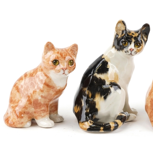 403 - A collection of four Winstanley studio pottery figures of cats, the largest 25cm high.