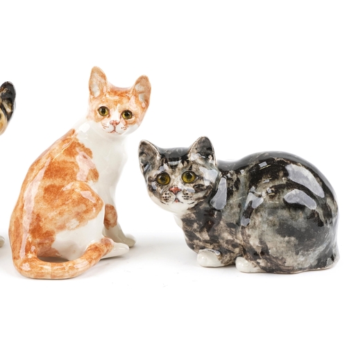 403 - A collection of four Winstanley studio pottery figures of cats, the largest 25cm high.