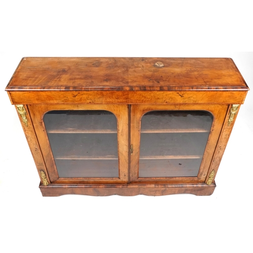 1031 - A mid Victorian figured mahogany and walnut two door pier cabinet with gilt metal mounts, 109cm H x ... 